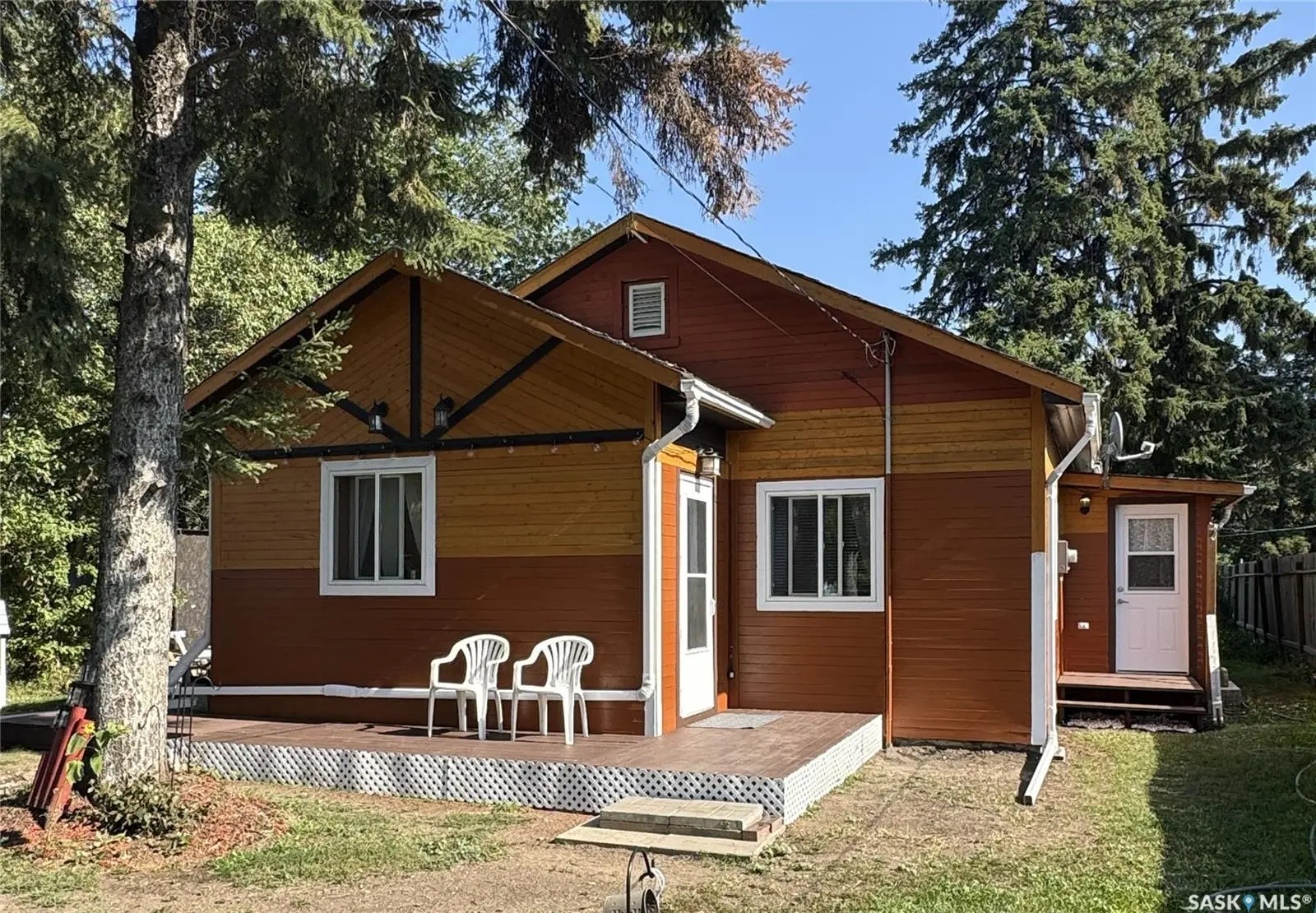 Exterior photo of 3010 2nd Avenue E, Waldheim, SK, showing front view of home surrounded by trees and garden